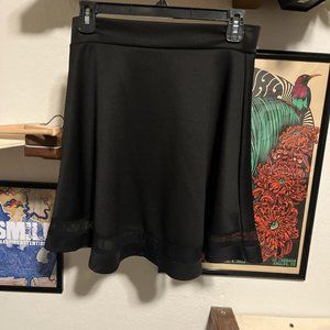 Black skirt with sheer design pattern across the bottom